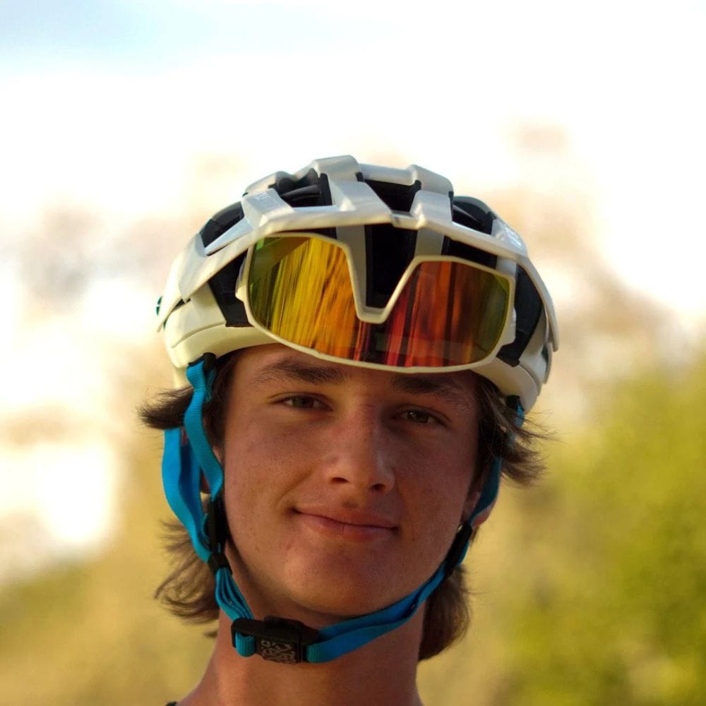 Person wearing a helmet with reflective goggles outdoors