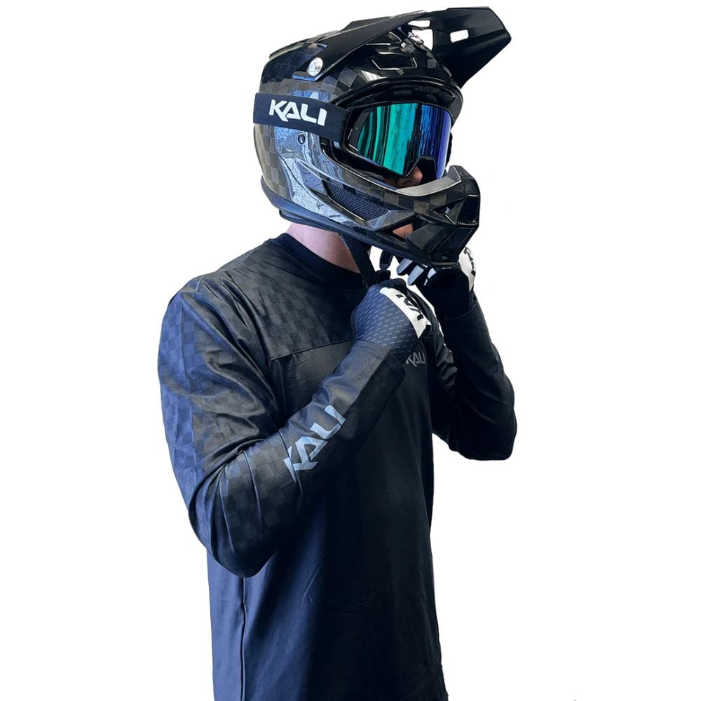 Person wearing a Kali helmet and matching outfit on a white background